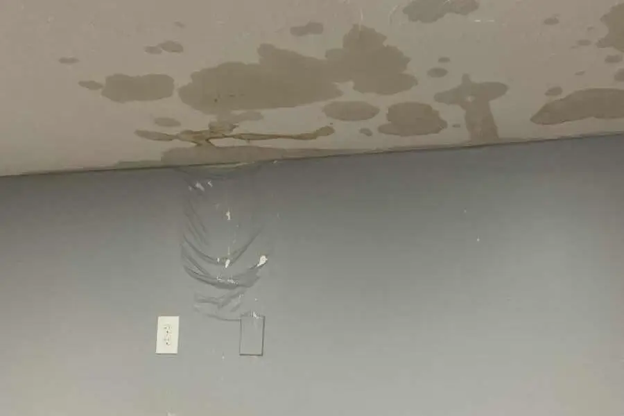 Water damage and staining on a ceiling, indicating a leak or plumbing issue that may require a sump pump or other remediation.
