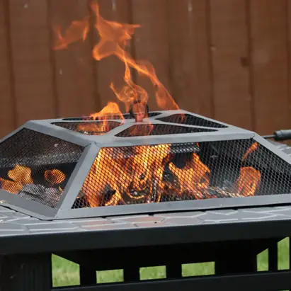 Stock image of a charcoal firepit with bright orange flames.