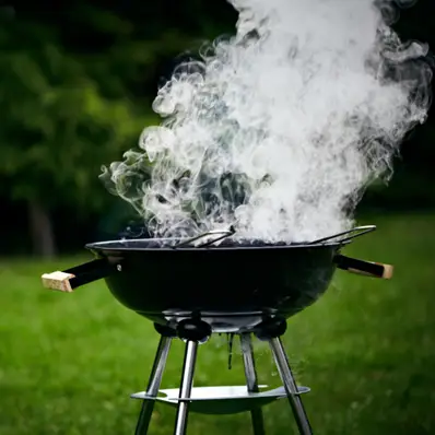 The image shows a close-up view of steam or smoke rising from a hot cooking surface, such as a barbecue or grill.