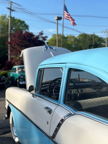 Blue classic car with its hood propped open
