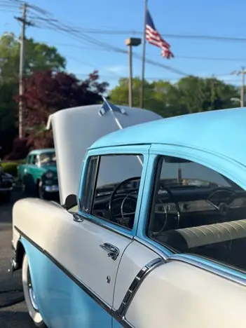Blue classic car with its hood propped open
