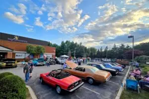 Image of DAI Cruise Nights with classic cars surrounding the community