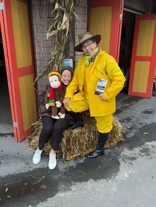DAI employee at a Dinosaur themed DAI Truck to hand out candy at a local trunk-or-treat event