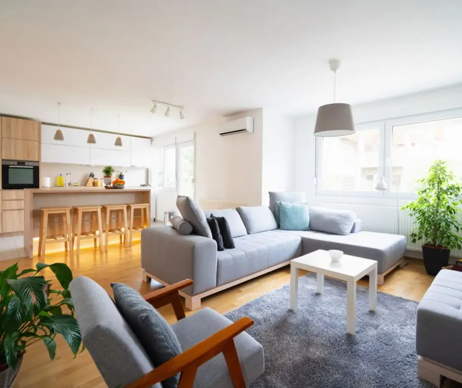 A clean interior of a home, showing off an open floor plan concept with the living room and kitchen in frame.